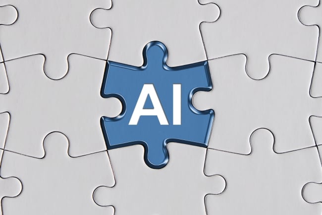 A blue jigsaw puzzle piece with the letters "AI" sits in the center of a puzzle; all the other pieces are white and blank.