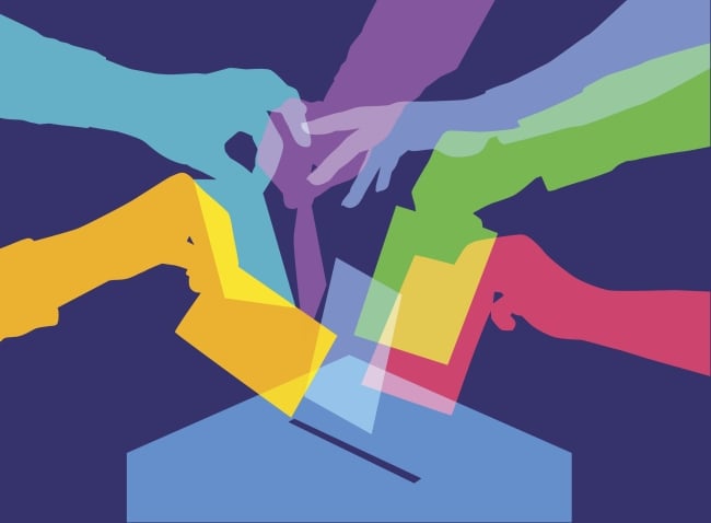 A brightly colored illustration featuring silhouettes of seven arms, all in different colors, reaching toward a ballot box to drop ballots.