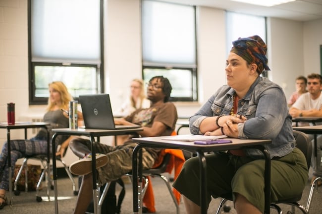 Students sit at desks in an Erie County Community College classroom.