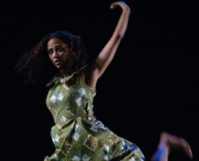 A woman in a green dress dances