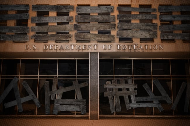 A photo illustration of a boarded-up Department of Education building