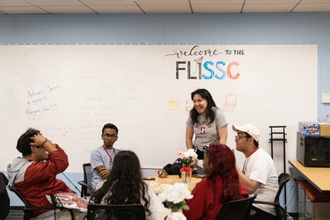 A group of students sit and chat in a circle at Stanford University's center for first-generation, low-income students