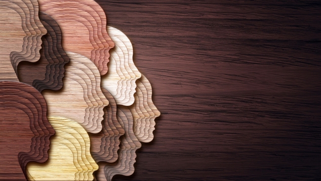 An abstract-style illustration featuring a collage of faceless heads representing people of a wide variety of races. 