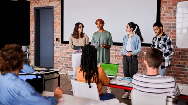 Group of students giving a presentation to classmates