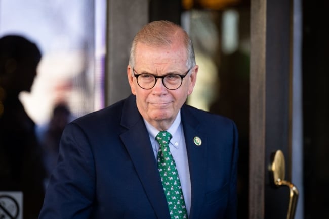 Tim Walberg, a white man wearing glasses and a green tie