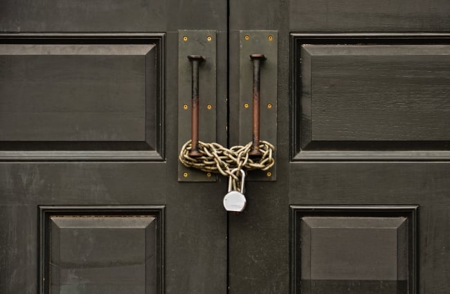 A photo of a door that is chained shut and locked.