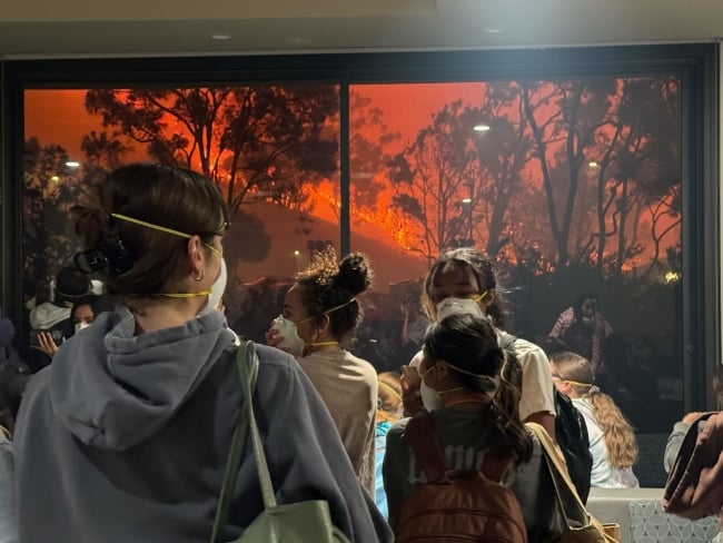 Pepperdine University students wear N-95 masks while watching the Franklin fire creep toward the Malibu campus.