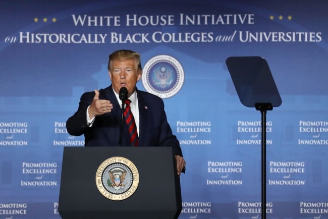 Donald Trump stands at a podium. A backdrop behind him reads "White House Initiative on Historically Black Colleges and Universities"