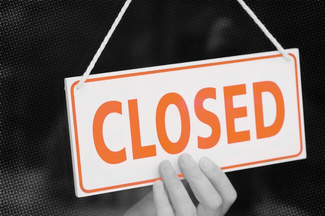 An orange and white sign that says "closed."