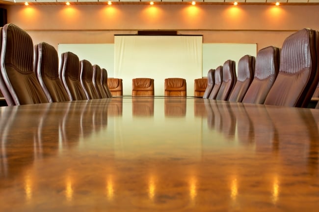 A photo of an empty boardroom table.