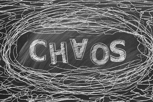 A black-and-white illustration of the word "Chaos," with the A upside down, surrounded by a messy doodle amounting to tangled lines.