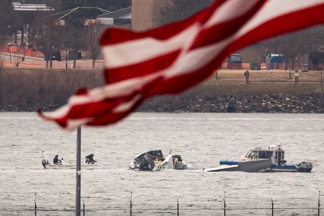 A photograph of wreckage in the Potomac River from the Jan. 29 plane crash resulting from the collision of an American Airlines jet and a Black Hawk helicopter near Reagan National Airport. Part of the American flag can be seen waving in the foreground of the picture.
