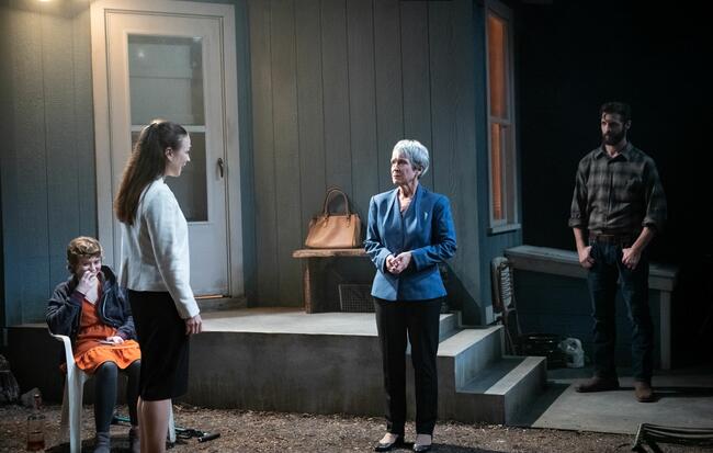 A darkly lit image of four actors on stage during the Studio Theatre’s 2022 production of Will Arbery's "Heroes of the Fourth Turning."