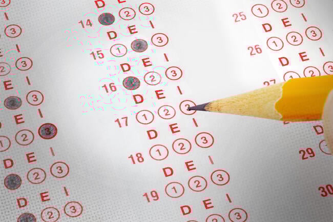 A scantron answer sheet with a pencil filling in some of the bubbles, but instead of being labeled A, B, C, the bubbles are labeled D, E, I.