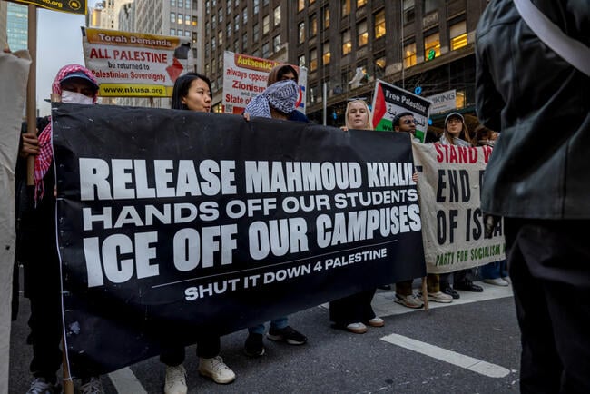 A photo of demonstrators with a large banner saying "Release Mahmoud Khalil Hands Off Our Students ICE Off Our Campuses Shut It Down for Palestine."