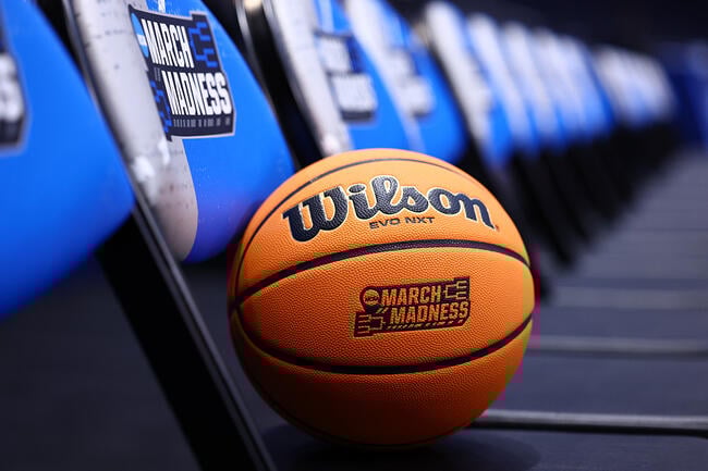 A basketball with the 2025 NCAA March Madness logo sits on a chair.