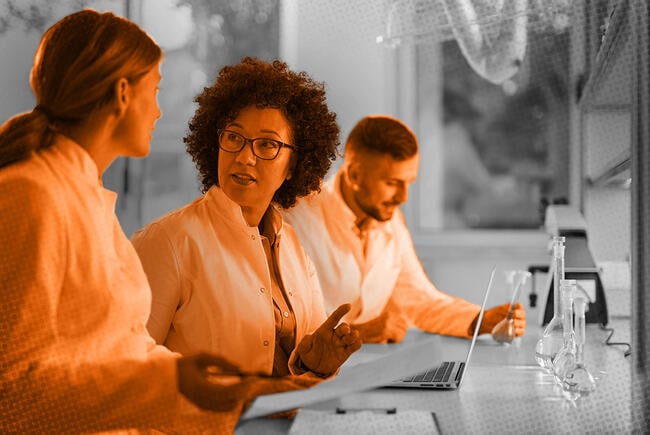 Photo illustration of scientists reviewing documents