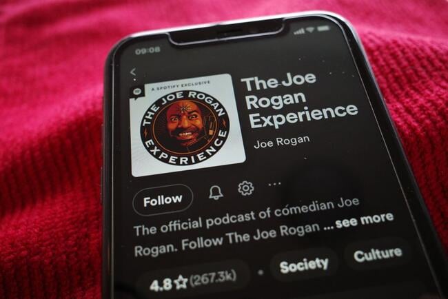A photo of a smartphone displaying the Spotify landing page for "The Joe Rogan Experience."
