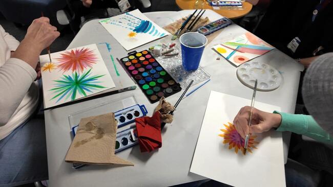 Students practice mindfulness techniques while painting with watercolors