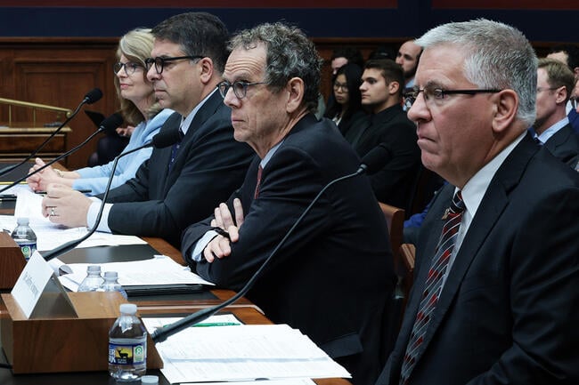 A photo of four people seated at a table in a hearing room in the U.S. Capitol