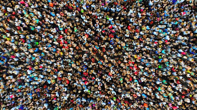 A photo of a large crowd of people gathered in one place, taken from overhead with a drone.