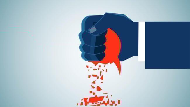 An illustration of a human hand squashing a red speech bubble in its fist.