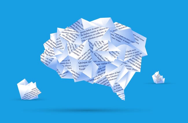 An illustration of a human brain made out of different pieces of paper with typed text on them, against a blue background.