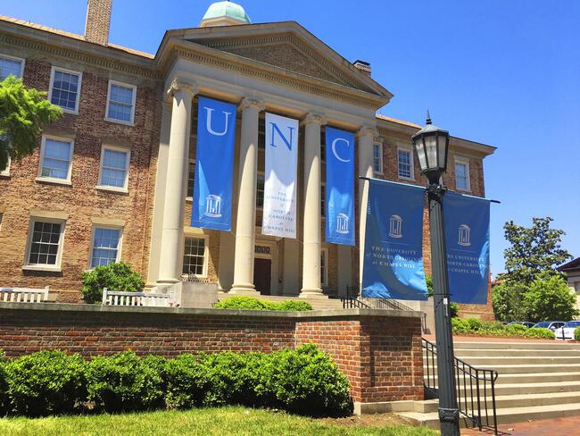 A building at UNC decorated with Tar Heel blue and white banners