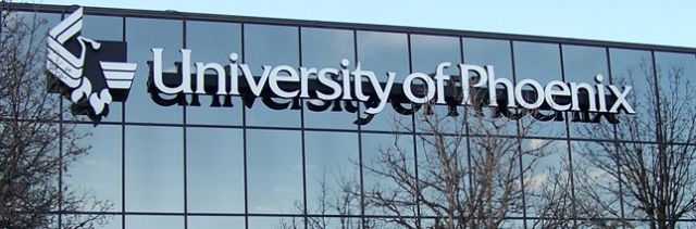 The University of Phoenix name and logo on the side of a glass building.