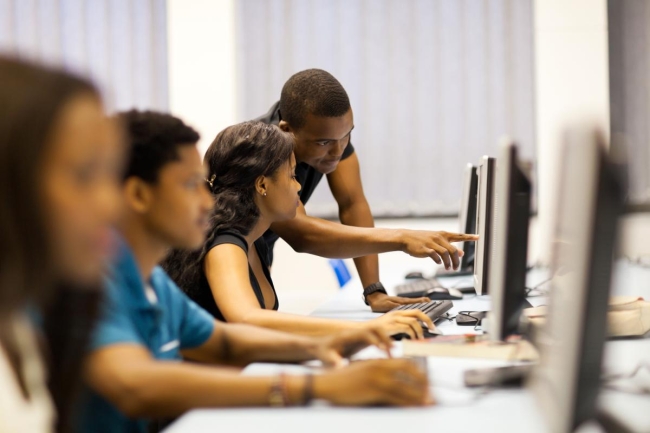 Students are shown in a computer lab.