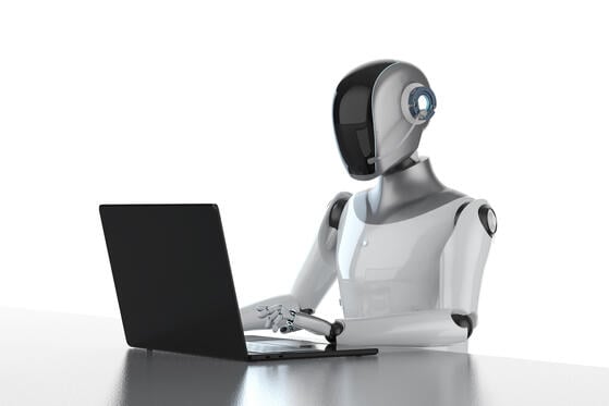 An illustration of a robot working at a computer.