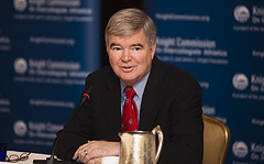 NCAA president Mark Emmert, a middle-aged white man, sits at a table with a silver pitcher in front of him.