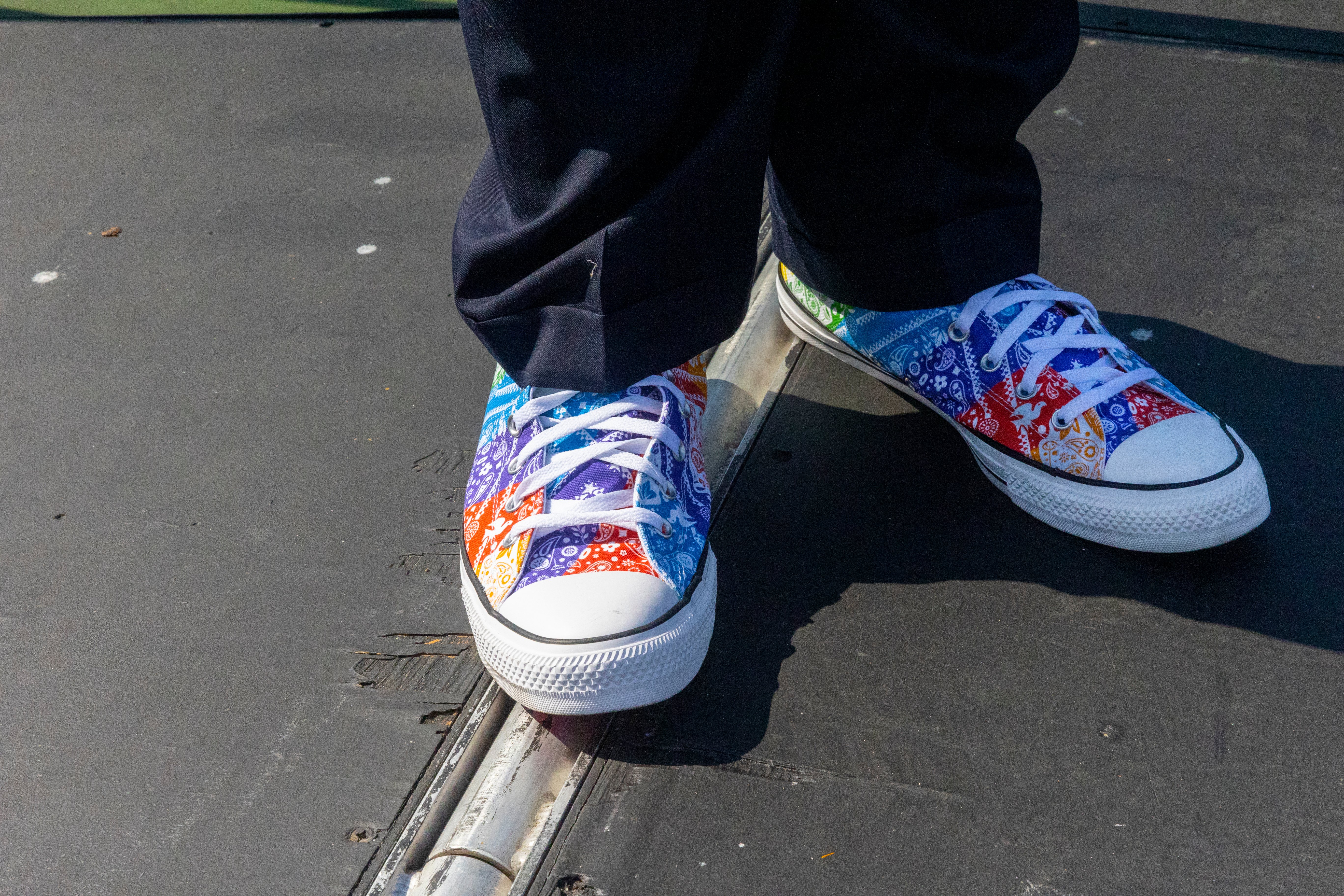 A close-up photo of the multicolored high-top shoes, Custom Chuck Taylor All Star Pride By You, as worn by Keith Curry.