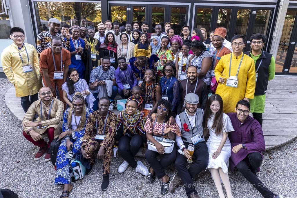 A group of people of different races, some of them in culturally specific clothing.