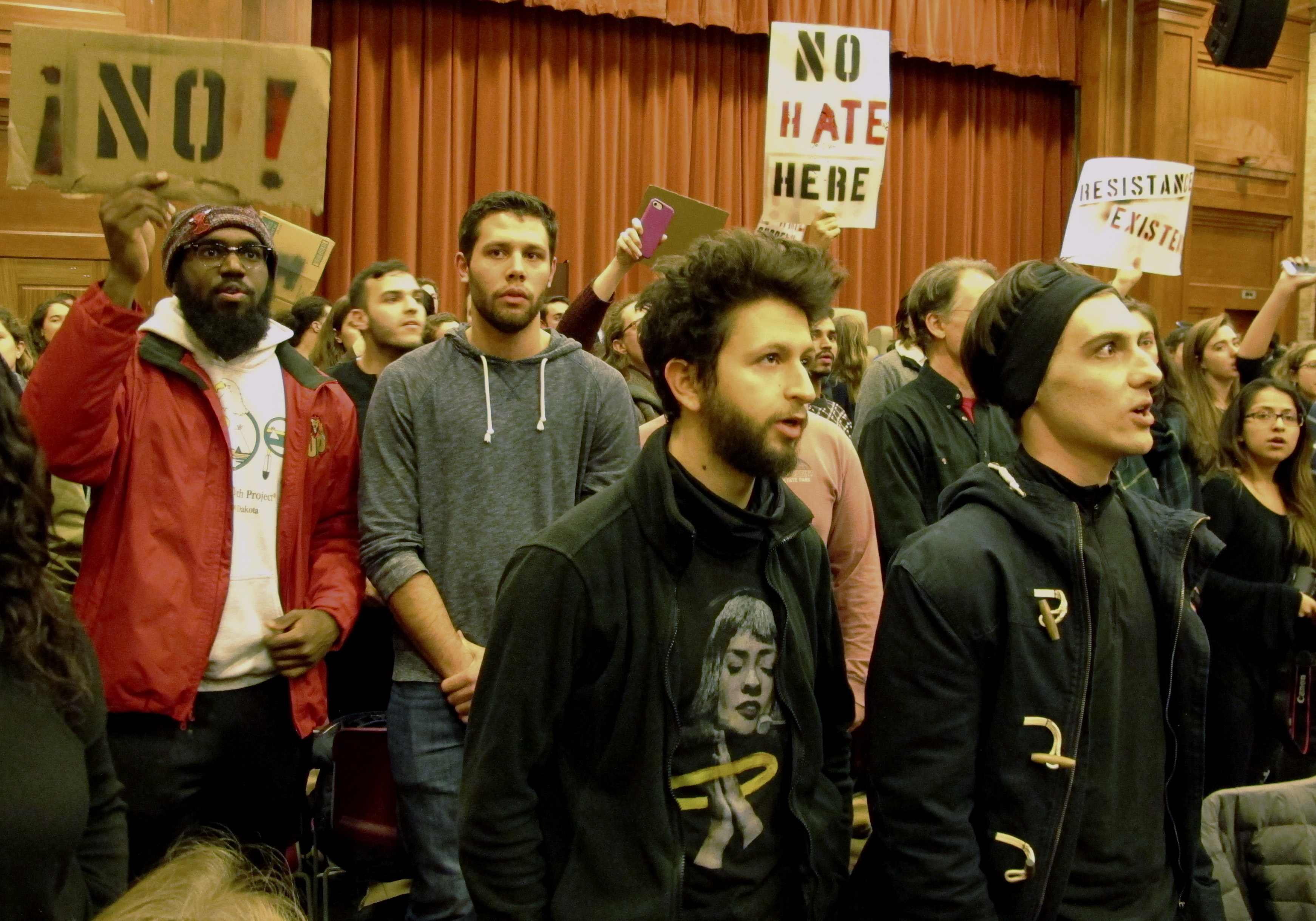 Protesters holding signs saying "No Hate Here"