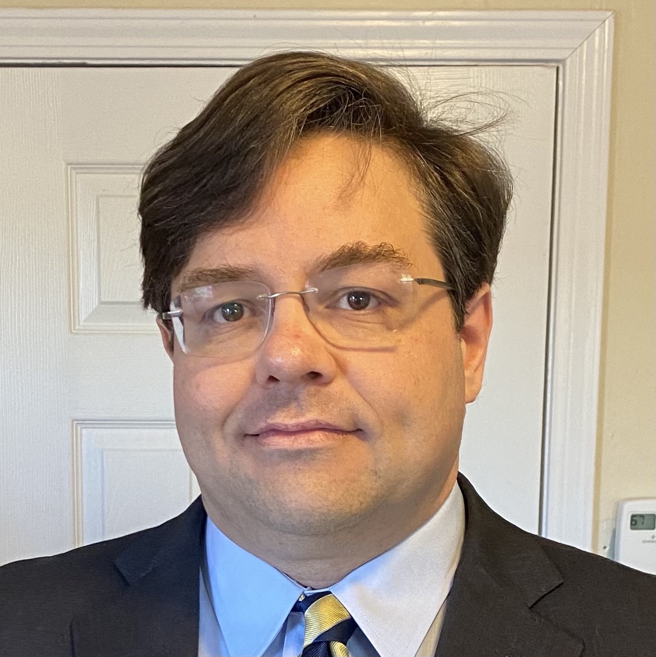 Scott Shireman, a white man wearing rimless glasses and a business suit.