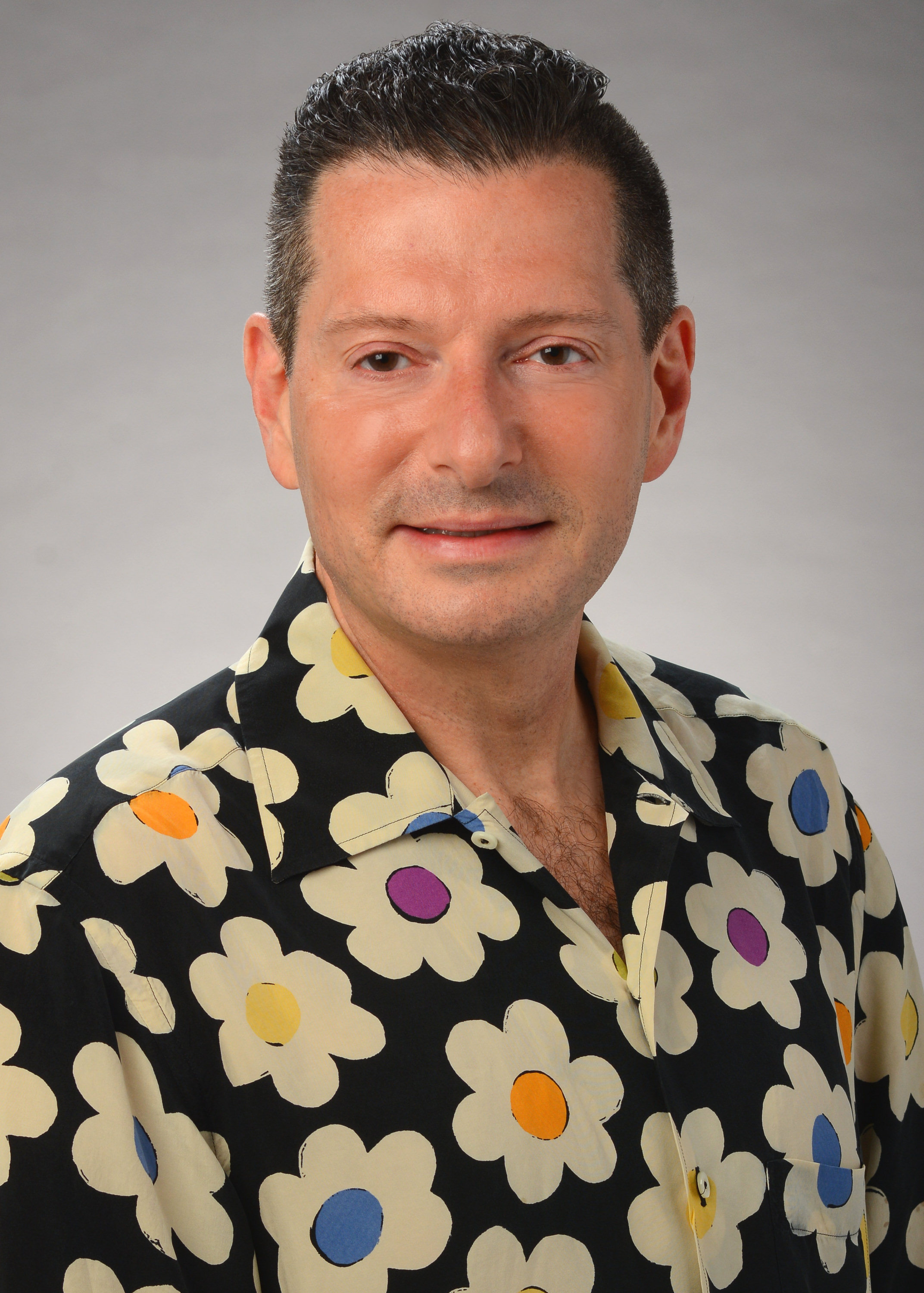 Mark Rosenbaum, a black-haired white man who wears a floral shirt.