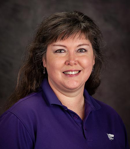 Laurel Littrell, a white woman with dark hair and bangs who is wearing a purple blouse.