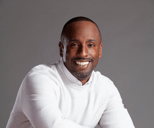 Stephen Green, a Black man wearing a white sweater.