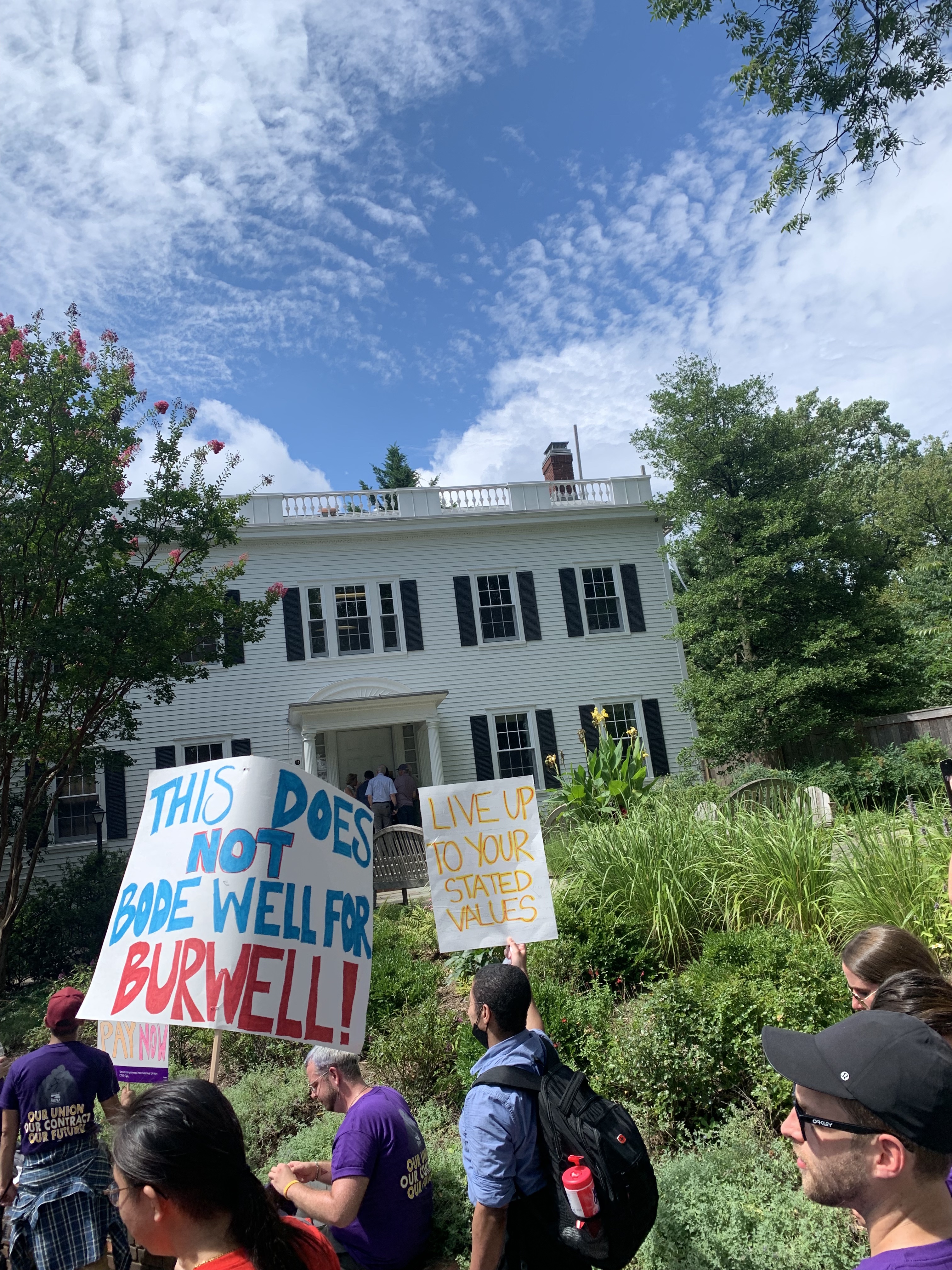 Striking American University staff members hold signs that say "This does not bode well for Burwell!"