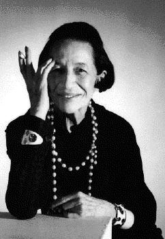 Black-and-white photo of Diana Vreeland, a white woman with short dark hair wearing a long necklace and holding a cigarette.