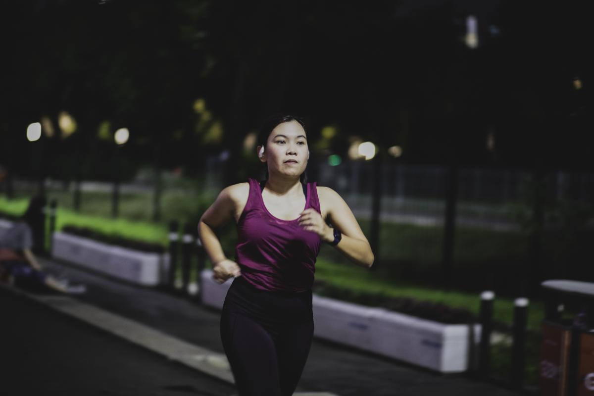 A female student runs alone at night.