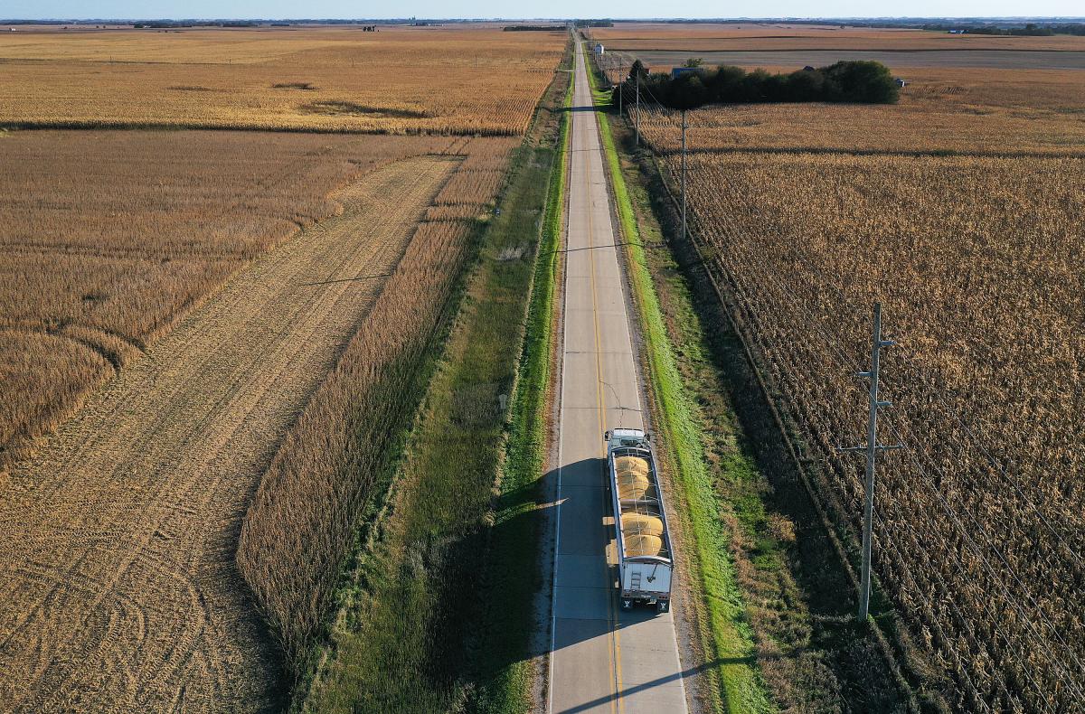 Overhead shot of a farm, with a road bisecting cultivated fields.