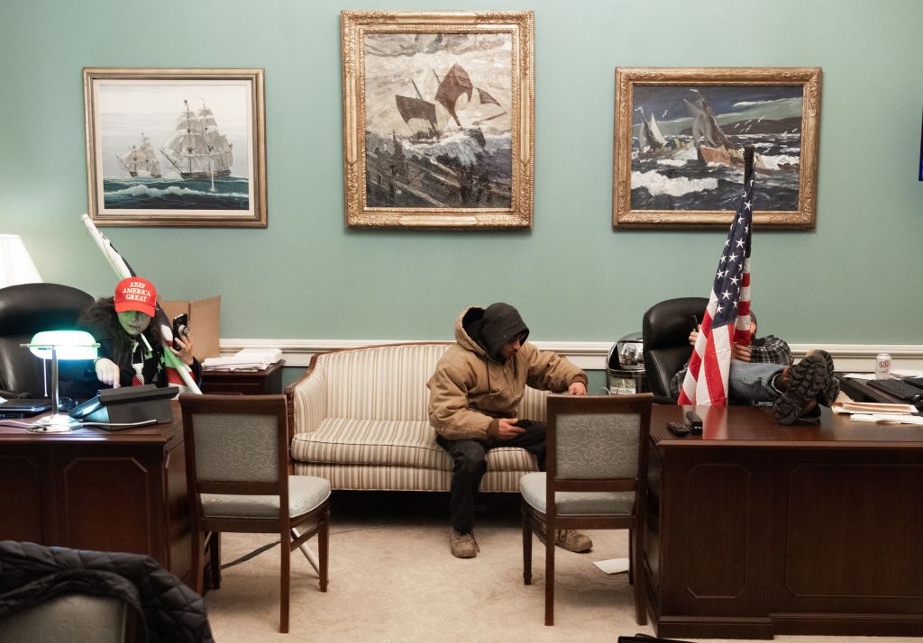 Rioters sit in Speaker of the U.S. House of Representatives Nancy Pelosi's office.