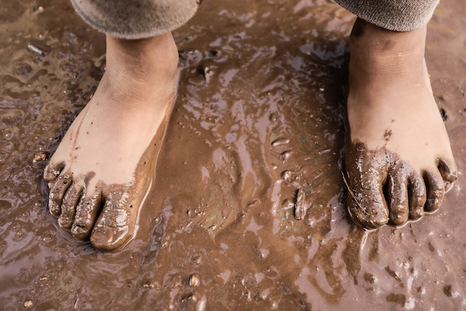 Bare feet in mud. 