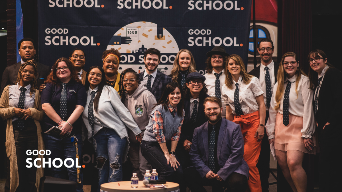 A group of Community College of Baltimore County students smile for a photo in front of a backdrop highlighting their podcast, "Good School."