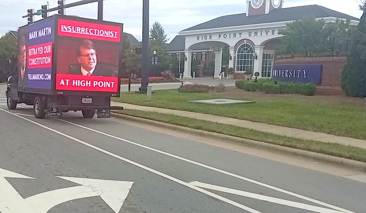 A truck with an image of Mark Martin and text claiming he betrayed the U.S. Constitution.