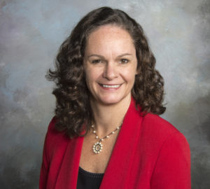 Juliette Landphair, a white woman with dark hair wearing a red jacket.