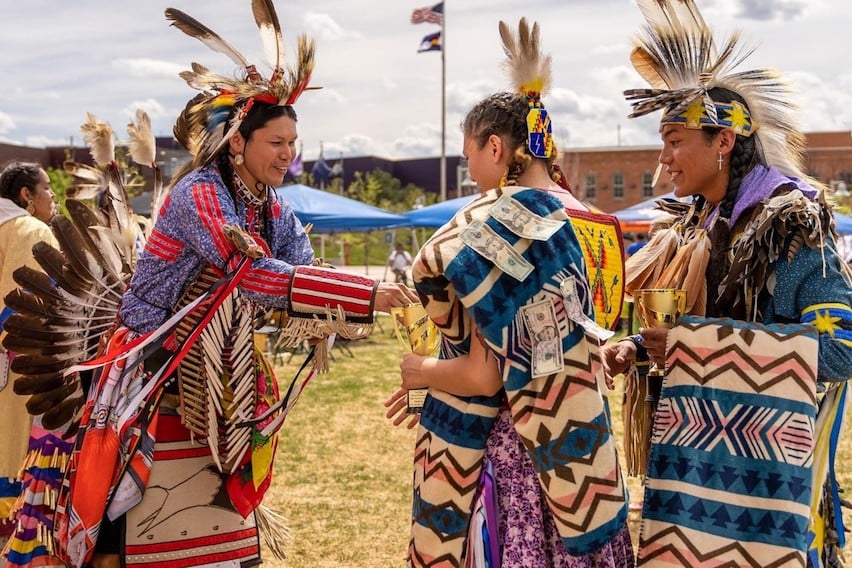 Native American students at MSU Denver are wearing colorful traditional tribal clothes.