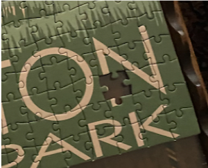 Close up of the puzzle with one piece missing.
